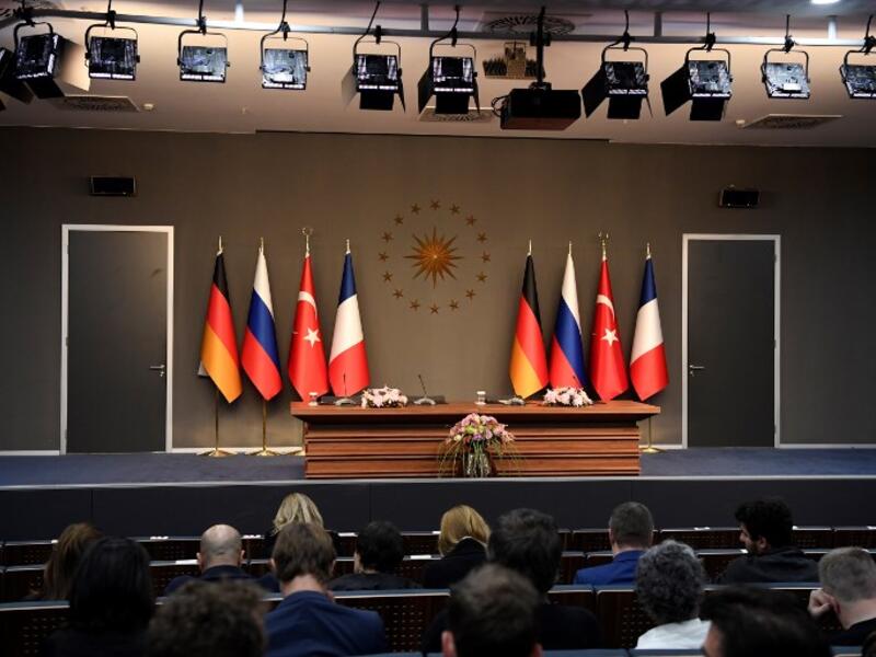 People sit in front of an empty stage ahead of a meeting during the "Four-way Istanbul summit on Syria", at Vahdettin Mansion in Istanbul, on October 27, 2018. (Bertrand GUAY / AFP)