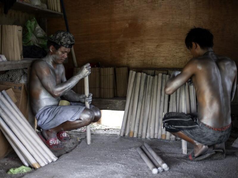 Workers covered with gunpowder material make fireworks for New Year celebrations in Bocaue, Bulacan, north of Manila on December 26, 2018. 
Noel CELIS / AFP