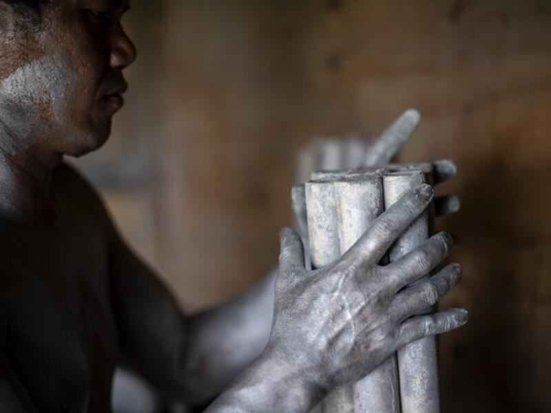 A worker covered with gunpowder material makes fireworks for New Year celebrations in Bocaue, Bulacan, north of Manila on December 26, 2018. 
Noel CELIS / AFP