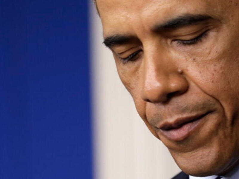 President Obama pauses to think while giving a speech.