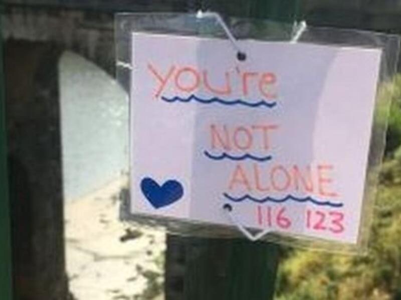 Police say a teenager who attached uplifting messages to a bridge to help people facing a mental health crisis has helped save six lives (Twitter)