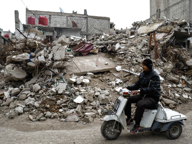 Mute 17-year-old Syrian Adnan, who lost both legs in 2014 following an airstrike as he was walking towards his father's store from school, rides a motorcycle in the rebel-held town of Douma, on the outskirts of the capital Damascus, on February 16, 2017. [AFP/Sameer Al-Doumy]