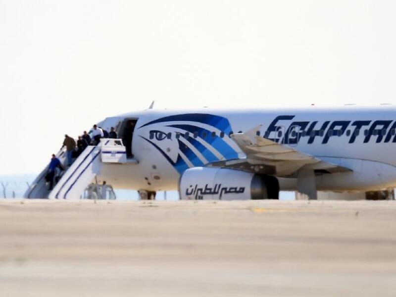Passengers disembark from the hijacked plane in Cyprus. (AFP / George Michael)