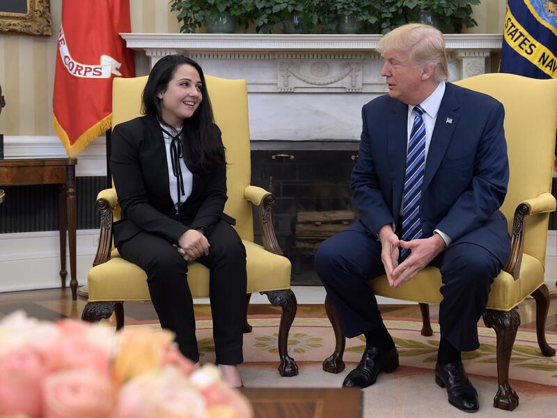 Donald Trump greets Egyptian-American Aya Hejazi, after working behind scenes to free her. (AFP/File)
