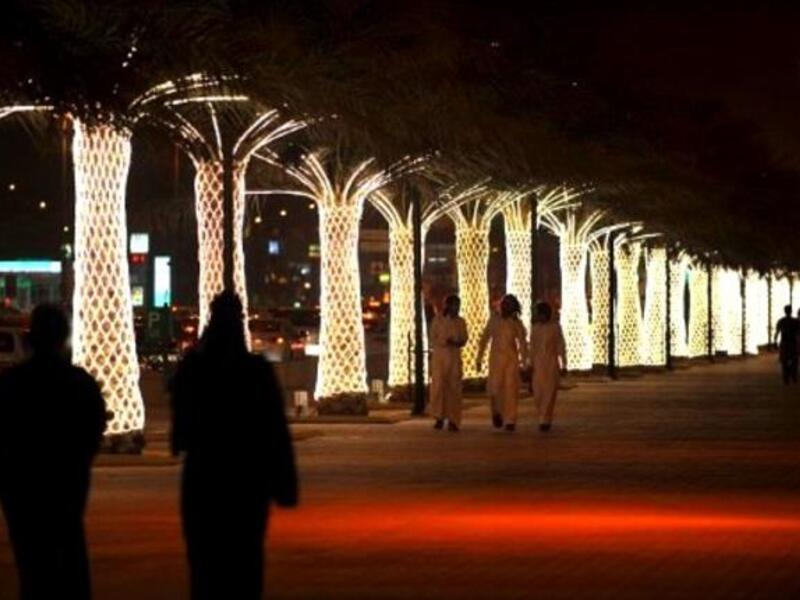 Saudi nights filled with lights: Saudis walk on King Abdullah Street decorated with lights ahead of celebrations for Eid al-Fitr. Lights mark the whole season of Ramadan and are aglow during Eid especially, sometimes complementing firework displays.