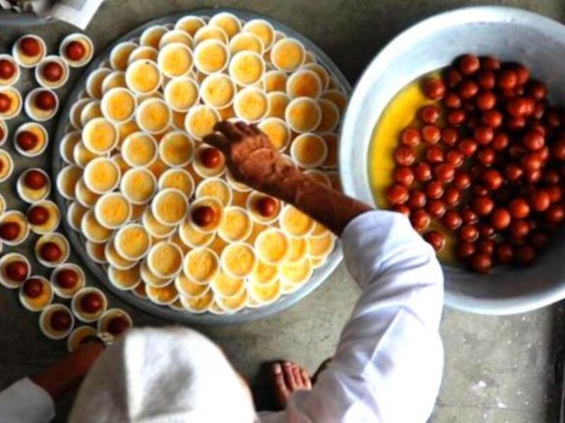 Nepal: Nepalese Muslim men prepare food to break the fast after the Jummat-Ul-Vida, the last Friday prayers, ahead of the Eid al-Fitr festival at the Kashmiri Mosque in Kathmandu. Sweets are often a center-piece in this three-day festival of a little decadence after a month of fasting. 