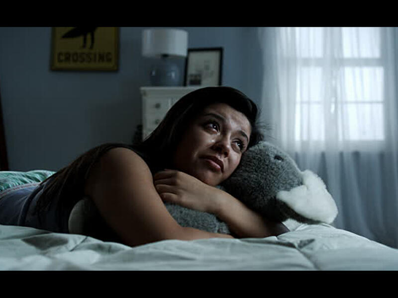 woman crying bed