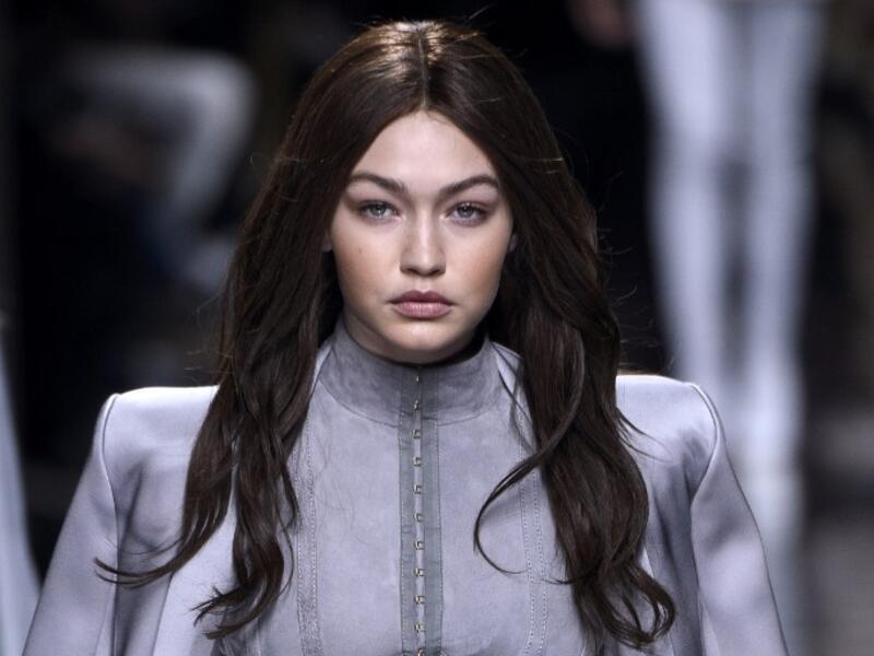 Gigi maintained her brunette locks while stepping out in Paris with Kendall after the show. (AFP/Martin Bureau)