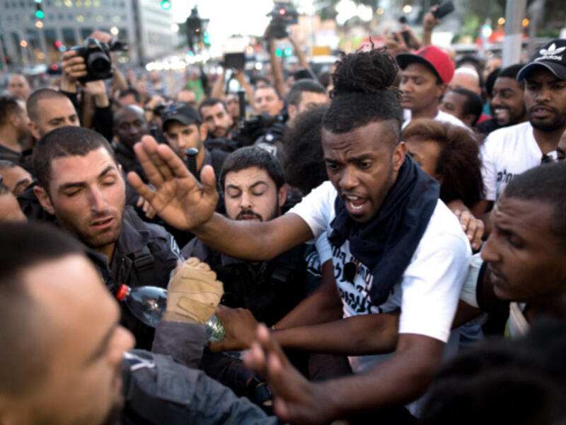 Ethiopian-Israelis and Israeli police scuffle in Tel Aviv last year (AFP/File)