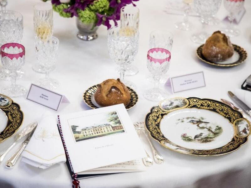 Menu, porcelain plates, glasses and tableware are pictured during the state dinner hosted by the French President for the South Korean President at the Elysee Palace in Paris, France, on October 15, 2018. 
(Christophe Petit-Tesson / POOL / AFP)


