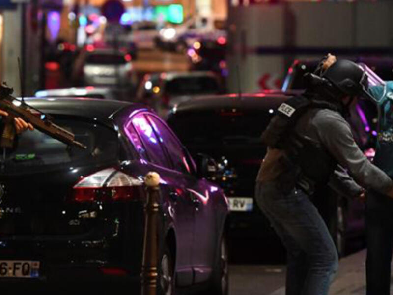 Police officers frisk a man on the Champs Elysees in Paris after the deadly shooting. (AFP)