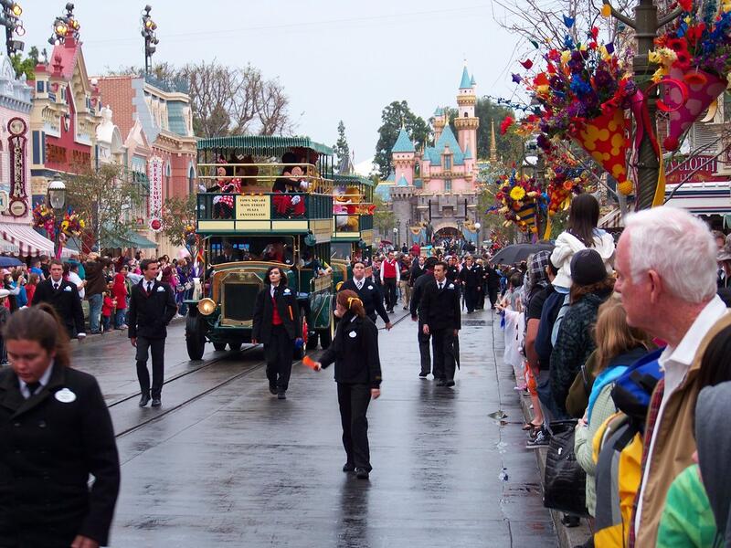 People gather to watch Disneyland characters in fairy vehicles. (popsugar.com)