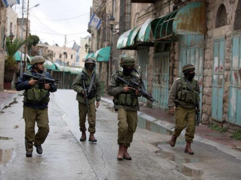 IDF soldiers are seen on patrol in Hebron. (AFP/File)