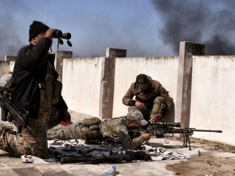 A sniper fires at targets during clashes with ISIS fighters in Mosul. (AFP/ File Photo)