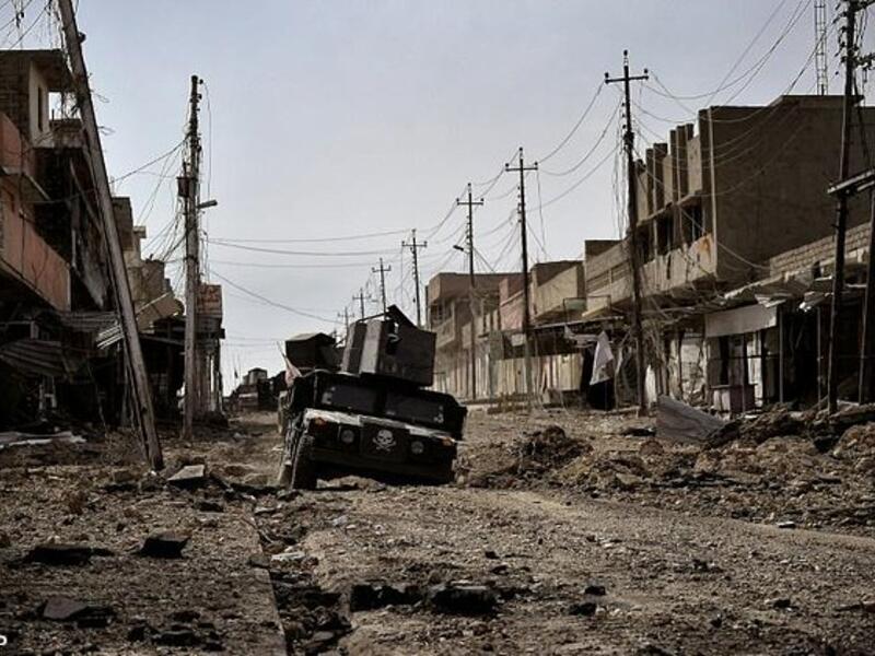 Iraqi special forces drive through a heavily damaged street in Mosul, on March 1, 2017. (AFP)