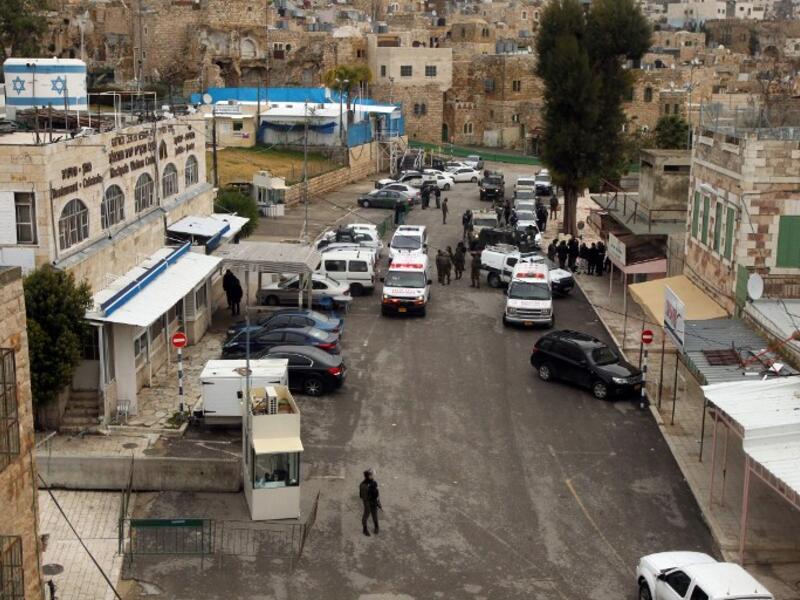 Police an ambulances respond to a shooting attack in January near the Ibrahimi Mosque. (AFP/Hazem Bader)