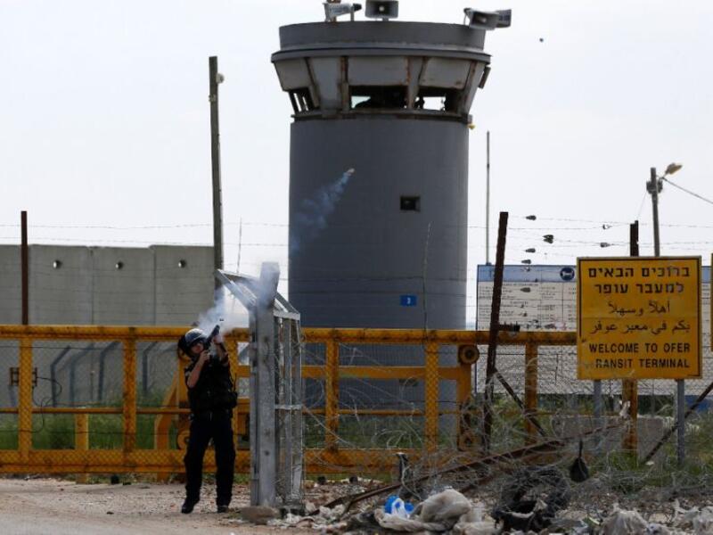 A file photo of Israeli security forces firing tear gas at protesters outside of Ofer prison. (AFP/File)