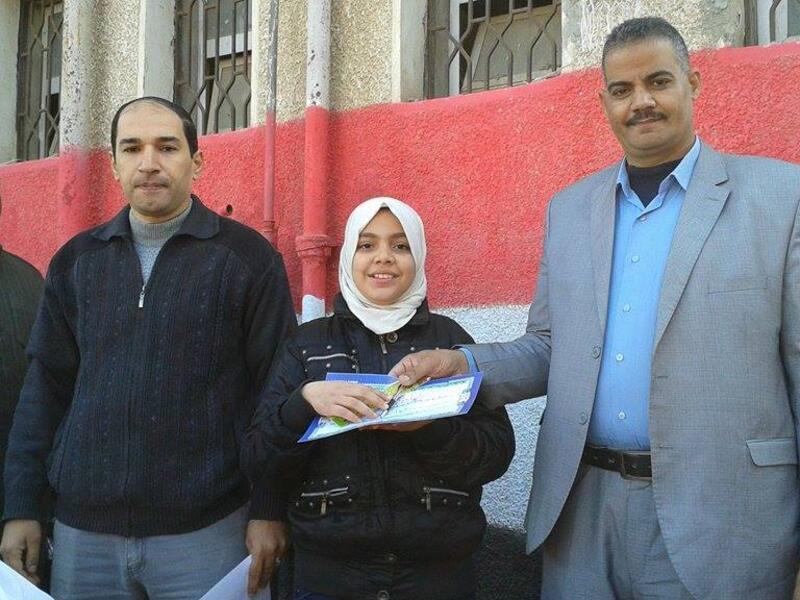 Yasser Muhammad Rashid (center left) outside the Kufr Suleiman Musa School (Facebook).