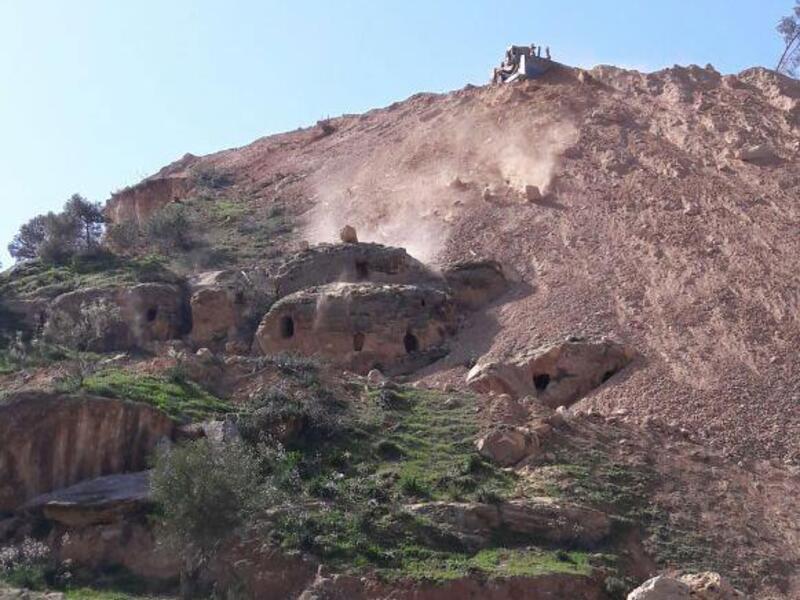 The tombs, dating back to the Bronze Age, were seen being “buried by bulldozers” being used to construct the new detour. (Photo courtesy of Jordan Times/Yousef Zuraiqat)