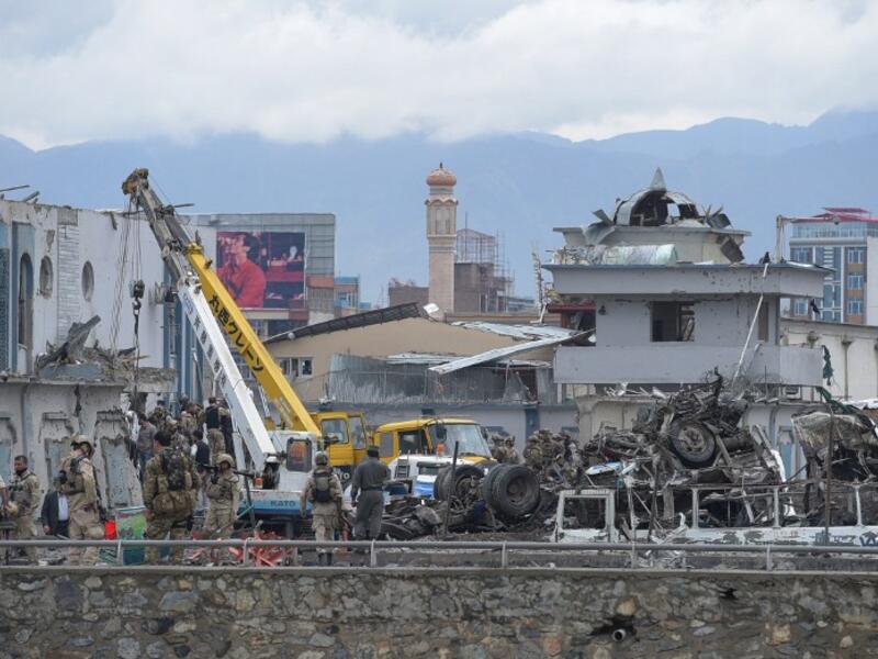 Afghan forces gather at the site of a car bomb in Kabul on April 19. (AFP/Shah Marai)