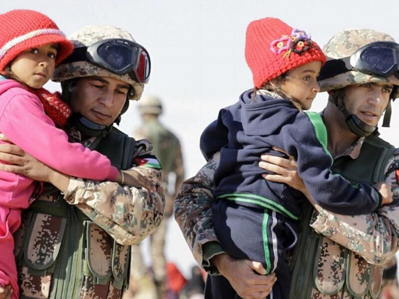In a new poll, 65 percent of Jordanian respondents believe that the government should encourage Syrian refugees to go back to their country. (AFP/ Khalil Mazraawi)