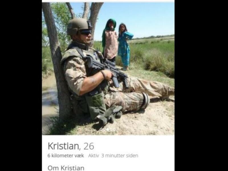 armed soldier posed near little Arab girls
