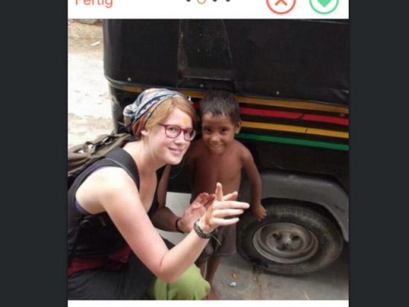 aid worker posing with foreign child