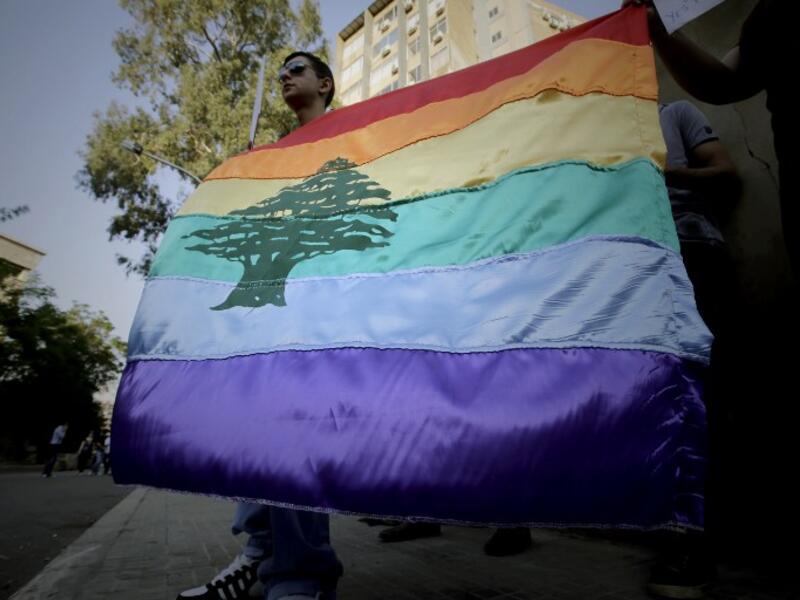 A Lebanese pride flag flies at a 2013 anti-homophobia rally in Beirut (Joseph Eid/AFP)
