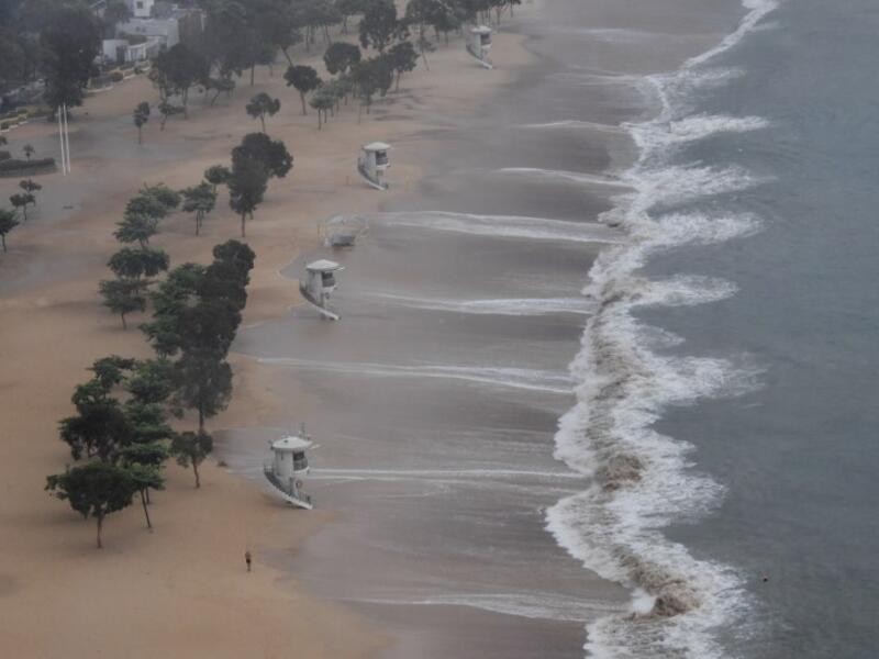 A man jogs along Repulse Bay beach after the hoisting of signal number 9 warning as super Typhoon Mangkhut starts to slam Hong Kong on September 16, 2018. 
Mark RALSTON / AFP