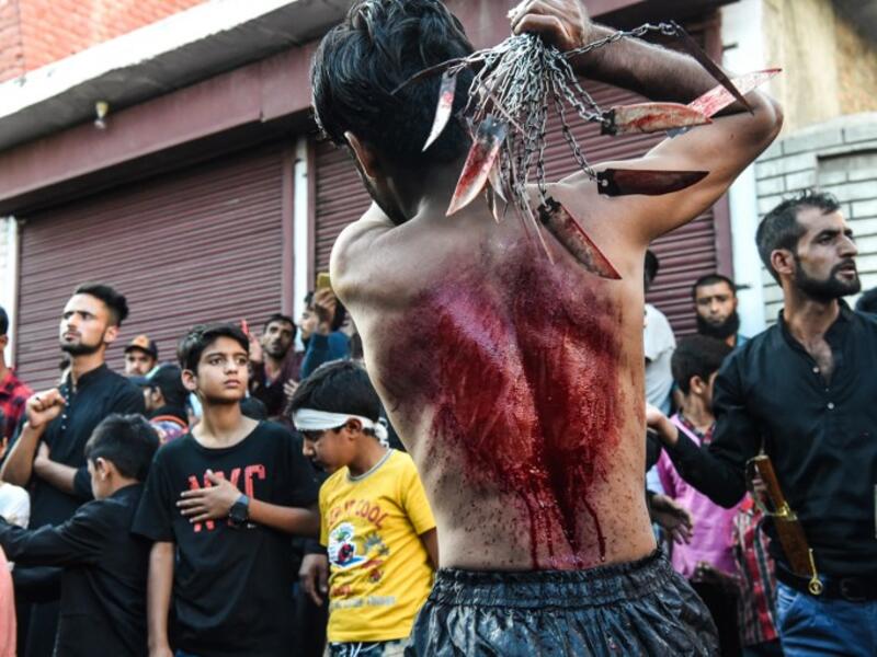 A Kashmiri Shiite Muslim mourner flagellates himself during a religious procession held on the seventh day of Ashura which remembers the slaying of the Prophet Muhammed's grandson in southern Iraq in the seventh century, in Srinagar on September 18, 2018. TAUSEEF MUSTAFA / AFP