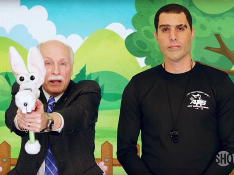 Larry Pratt the lobbyist and executive director emeritus of Gun Owners of America with Sacha Baron Cohen in the  "Who Is America?" series. (Showtime)