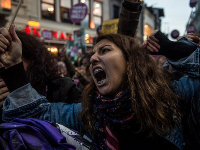 Women's rights activists react during clashes with Turkish riot police as they try to march to Taksim Square to protest against gender violence in Istanbul, on November 25, 2018, on the International Day for the Elimination of Violence against Women. 
BULENT KILIC / AFP