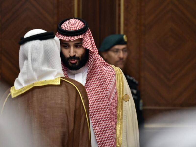 Saudi Crown Prince Mohammed bin Salman is pictured speaking to an unidentified man at the Diriya Palace in the Saudi capital Riyadh during the Gulf Cooperation Council (GCC) summit on December 9, 2018. Fayez Nureldine / AFP