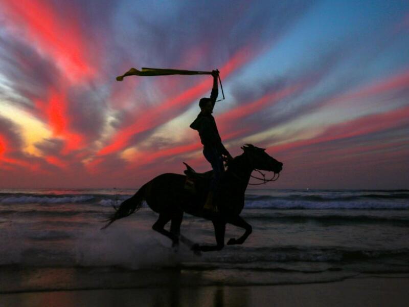 A Palestinian horseman rides on the beach at sunset west of in Gaza city on December 31, 2018. 
MAHMUD HAMS / AFP


