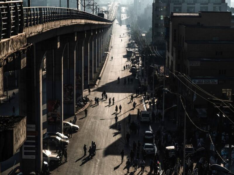People walk on a street in Addis Ababa on February 3, 2019 during the third Car Free Day promoted by local NGOs and the Ethiopian Government to appeal a healthy life style and a less air pollution of the capital city. 
EDUARDO SOTERAS / AFP