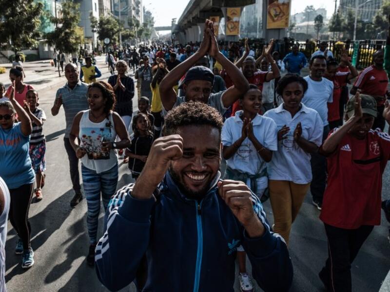 People take part in an exercise on a street in Addis Ababa on February 3, 2019 during the third Car Free Day promoted by local NGOs and the Ethiopian Government to appeal to a healthy life style and a less air pollution of the capital city. 
EDUARDO SOTERAS / AFP