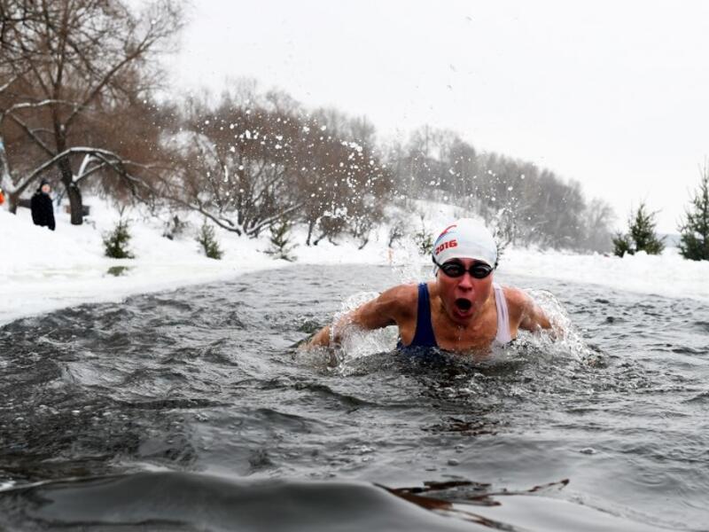 Natalya Seraya, the founder and chief of Moscow's ice swimming club "Walruses of the Capital", swims in a strip of water cut in the ice by the bank of the Moscow River on February 3, 2019. 
Kirill KUDRYAVTSEV / AFP