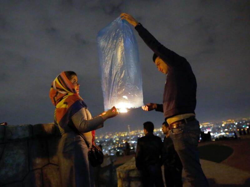 An Iranian couple lights a lantern in a park in Tehran on March 19 2018 during the Wednesday Fire feast, or Chaharshanbeh Soori, held annually on the last Wednesday eve before the Spring holiday of Noruz.
STRINGER / afp