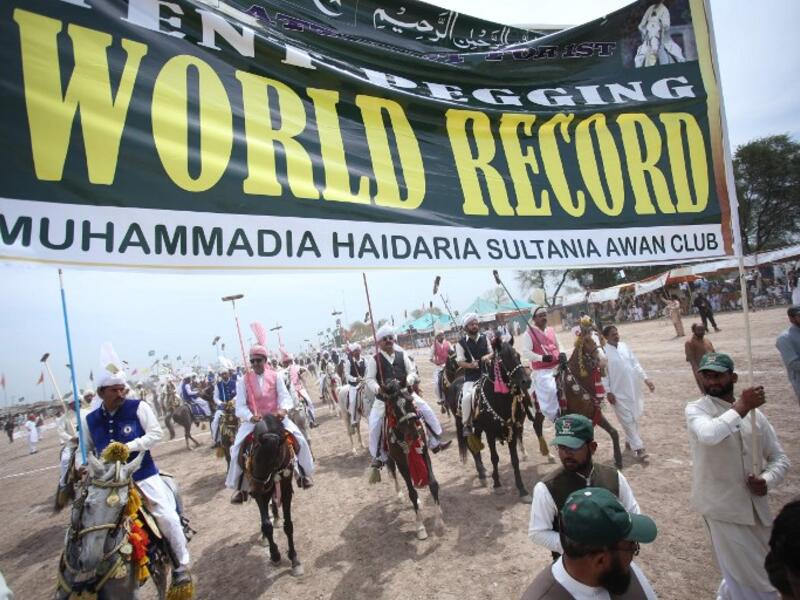 Pakistani horse riders during an attempt for a Guinness World Record for tent pegging in Khanewal district in Punjab province.
SS MIRZA / AFP