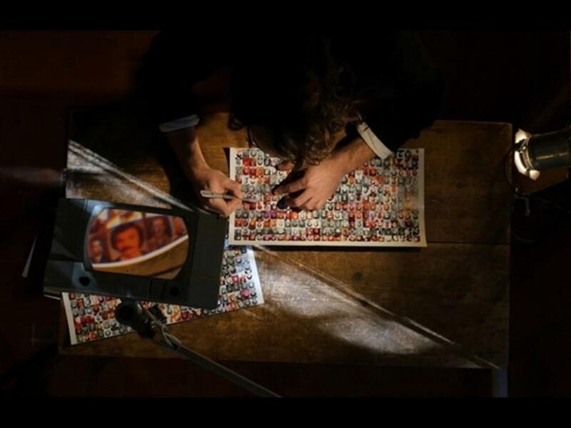 Halwani removes the portrait of a missing person from a collection of such portraits, "Erased, __ ascent of the invisible." (Photos courtesy of TIFF)