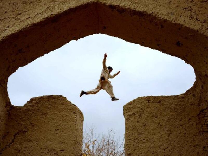 An Afghan boy plays in the ruins of a house that at one point belonged to the 13th-century Persian poet, Islamic scholar and Sufi mystic Jalal ad-Din Muhammad Rumi on the outskirts of Mazar-i-Sharif on November 25, 2015. (AFP/Farshad Usyan)