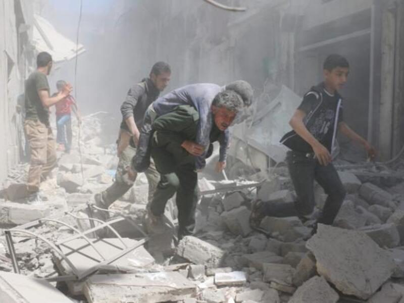 An injured man is evacuated from the aftermath of an air strike in the al-Qatarji area of Aleppo on Friday. (AFP/Ameer Alhalbi) 