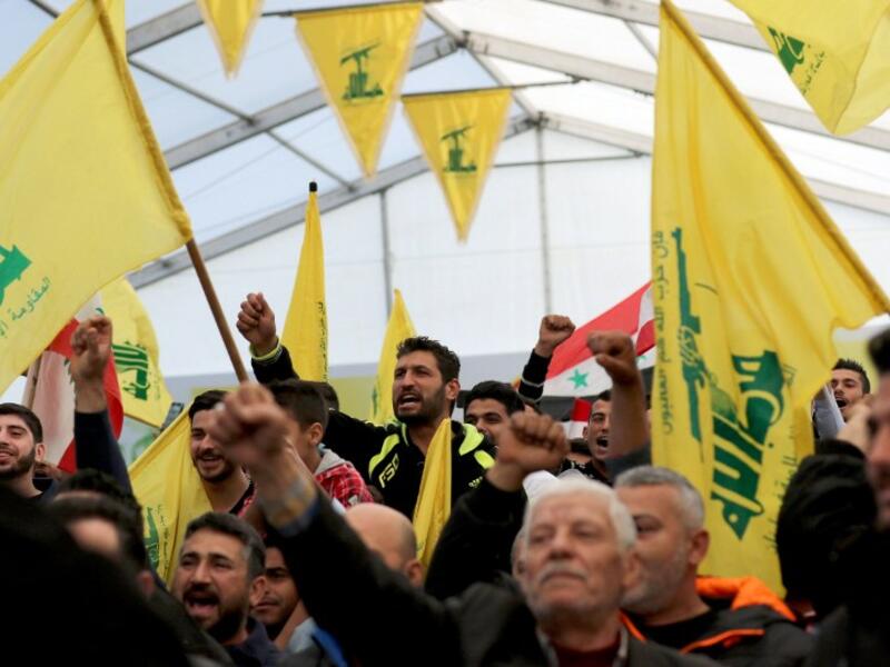 Supporters of Hezbollah chant slogans during a televised speech by leader Hassan Nasrallah. (AFP/File)