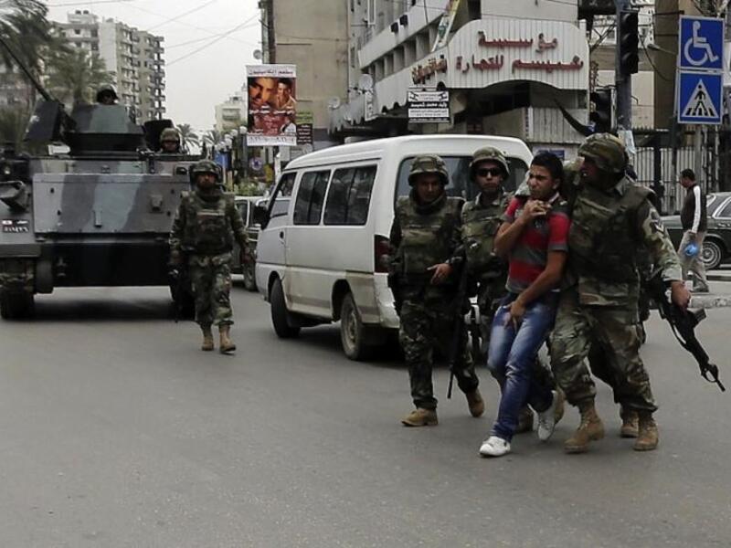 Lebanese army personal arrest a man in the northern Lebanese city of Tripoli. (AFP/File)