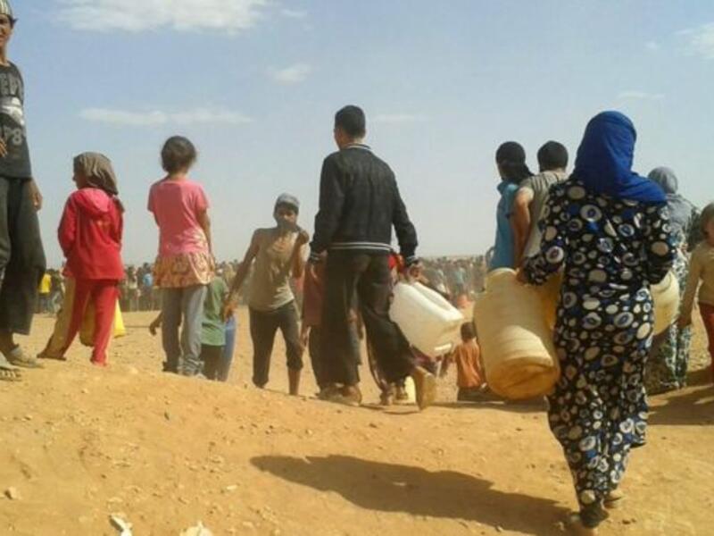 Syrian refugees look for water at the Rukban camp on the Jordanian border. (AFP/File)