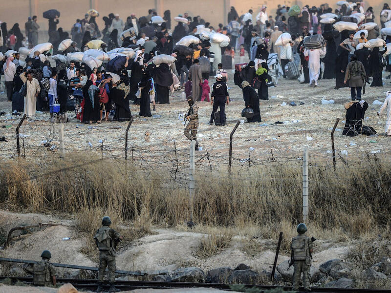 Turkish troops and Daesh militants stared at each other just a few yards apart across the barbed wire border as the civilians retreated. (AFP/File)