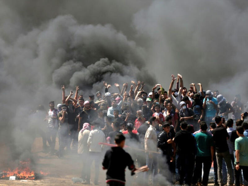 Palestinians burn tyres near the Strip border on May 14, 2018. (AFP/File Photo)