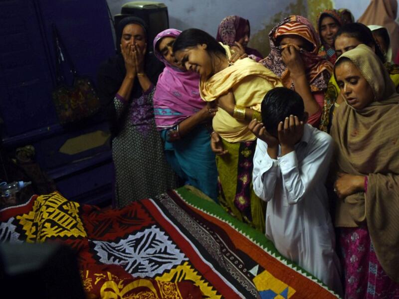 Pakistani relatives mourn over the coffin of a 13-year-old blast victim Zeeshan during his funeral on February 17, 2017, after a bomb blew up in the shrine of 13th century Muslim Sufi saint Lal Shahbaz Qalandar. (AFP/Asif Hassan)