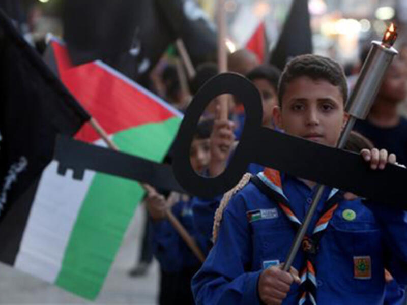 Palestinian children hold cutouts symbolizing the keys to houses left by Palestinians in 1948 as they take part in a rally on the eve of the 67th anniversary of the "Nakba Day" on May 14, 2015 in the West Bank city of Nablus. (AFP)