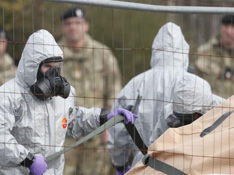 Military personnel wearing protective coveralls work to remove a vehicle connected to the nerve agent attack in Salisbury from a residential street in Gillingham, southeast England, on March 14, 2018. (AFP/ File Photo)